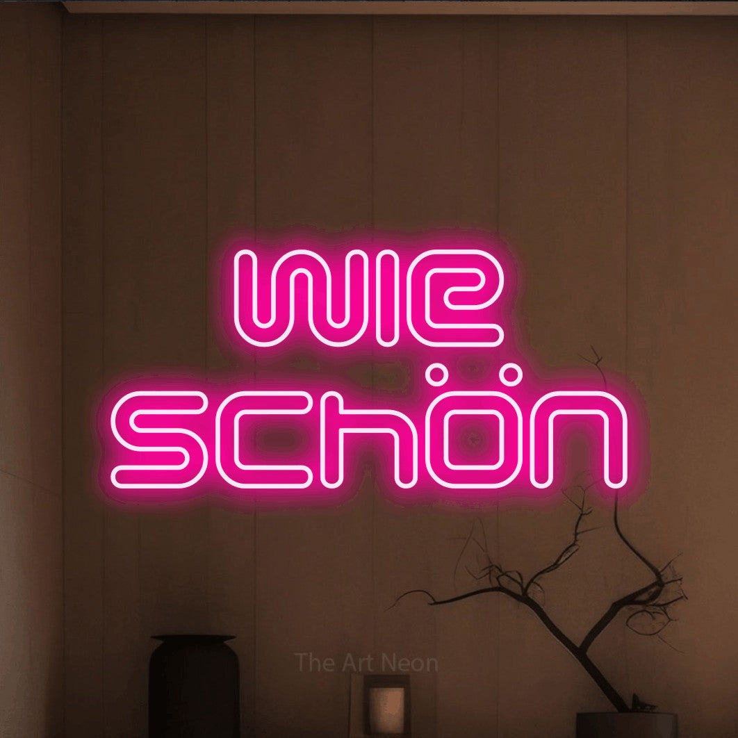 LED neon sign reading “Wie schön”, arranged in 2 lines.