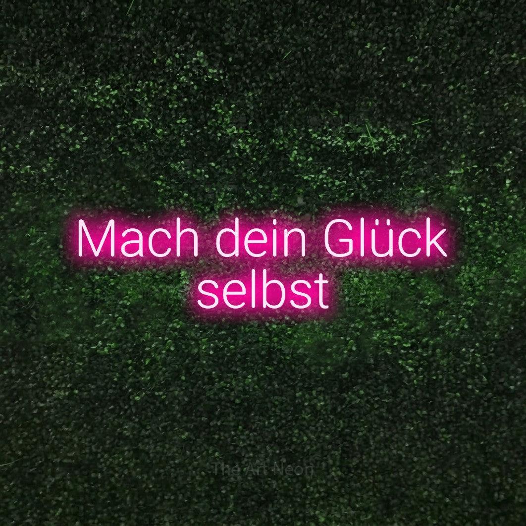 LED neon sign reading “Mach dein Glück selbst”, arranged in 2 lines.