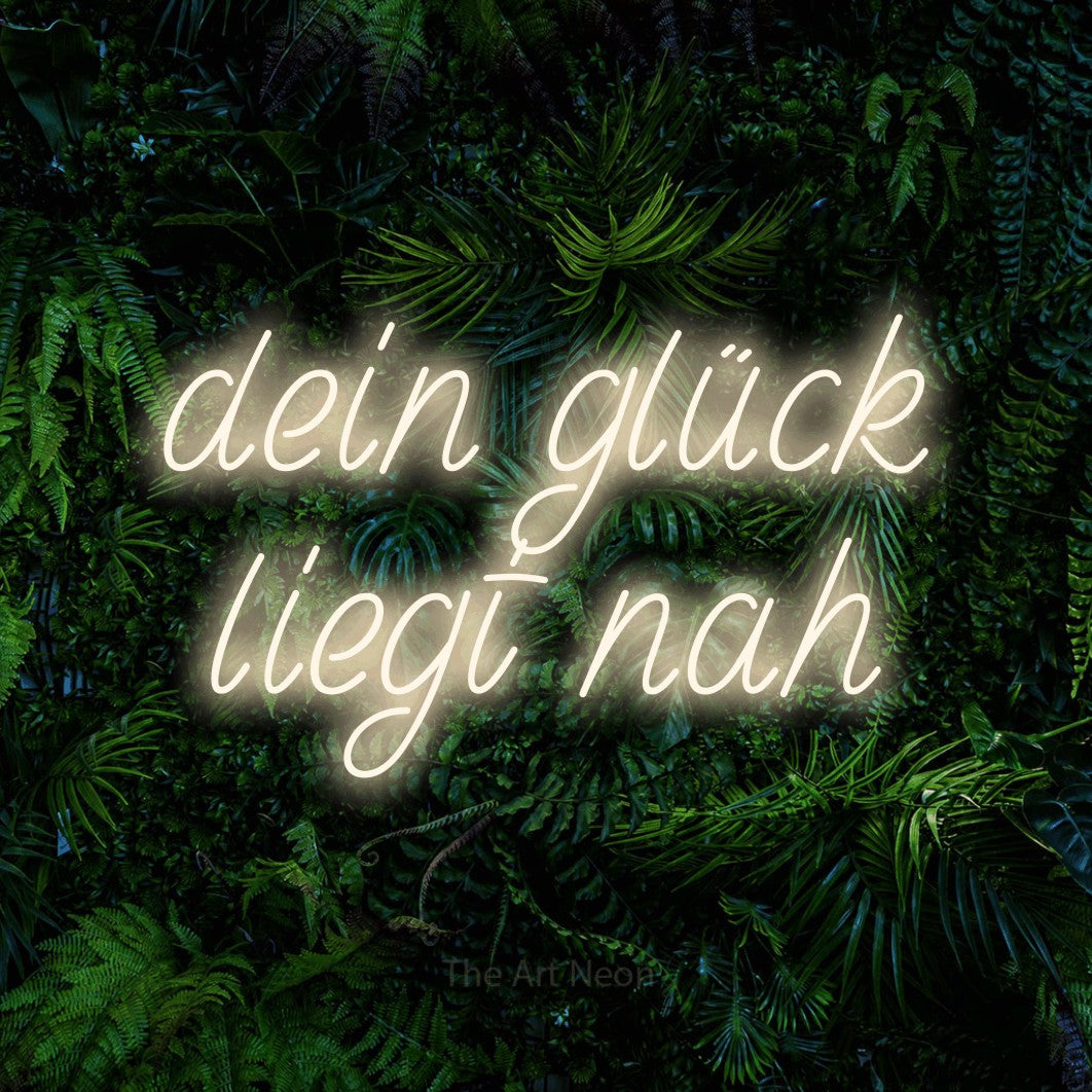 LED neon sign reading “dein glück liegt nah”, arranged in 2 lines.