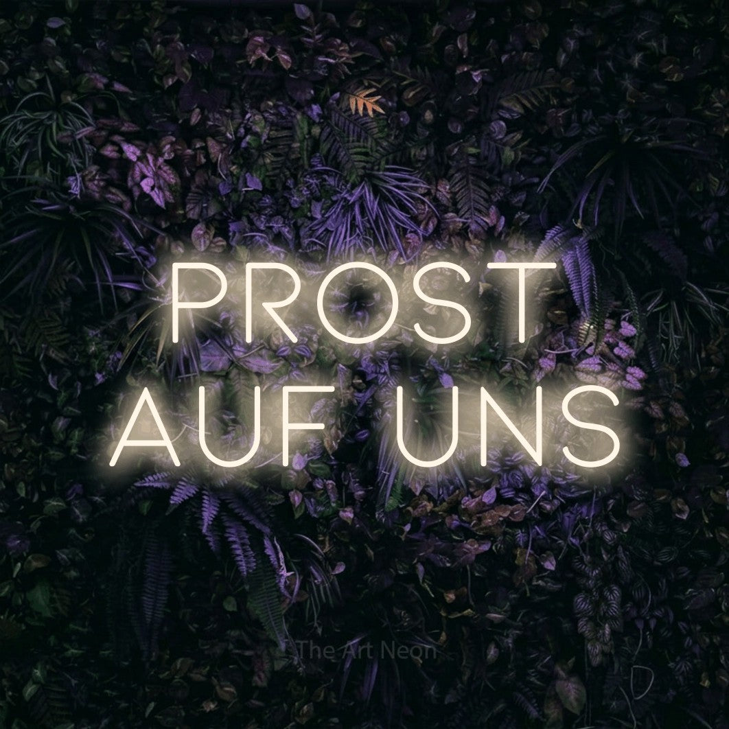 LED neon sign reading “prost auf uns”, arranged in 2 lines.
