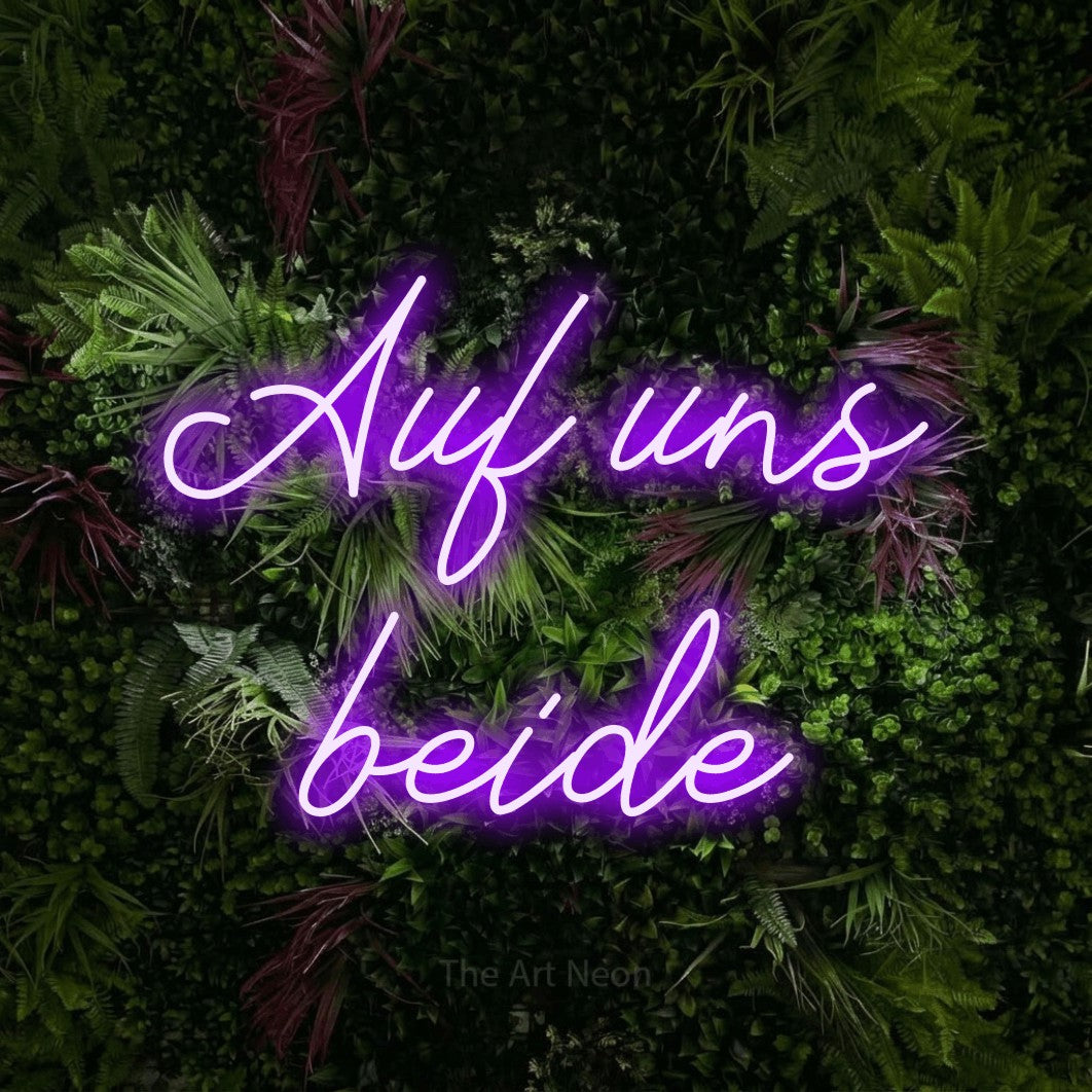 LED neon sign reading “Auf uns beide”, arranged in 2 lines.