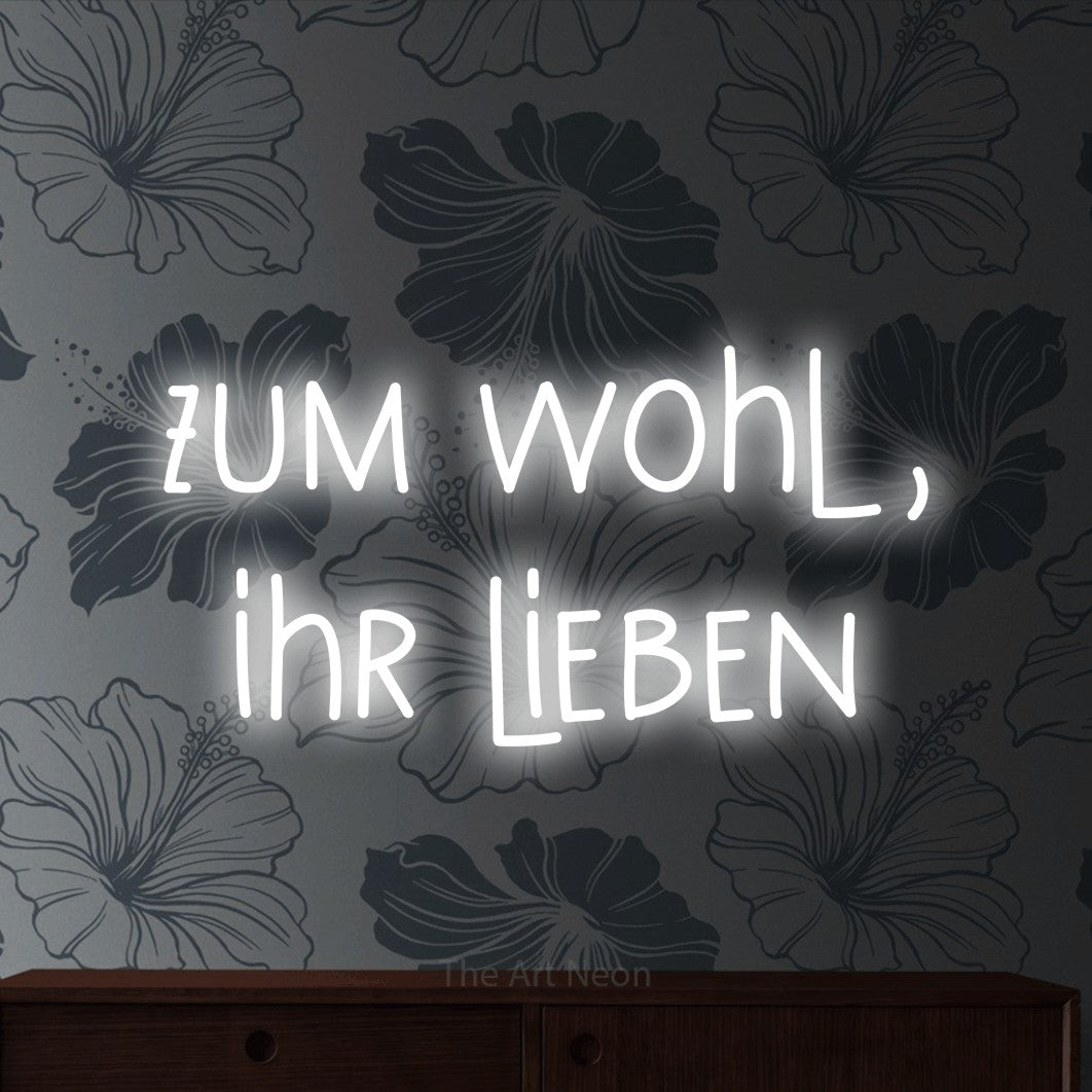 LED neon sign reading “zum wohl, ihr lieben”, arranged in 2 lines.