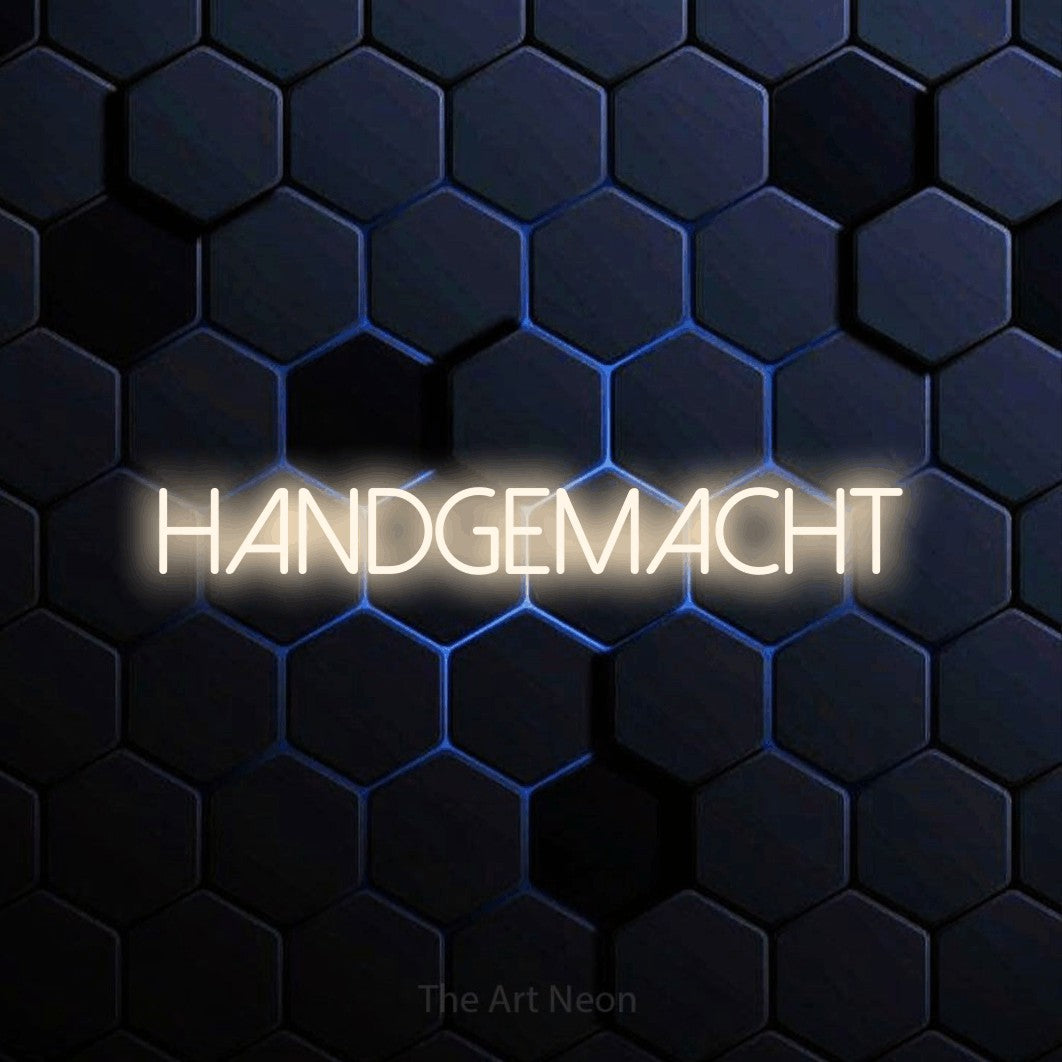 LED neon sign reading “Handgemacht”, arranged in a single line.