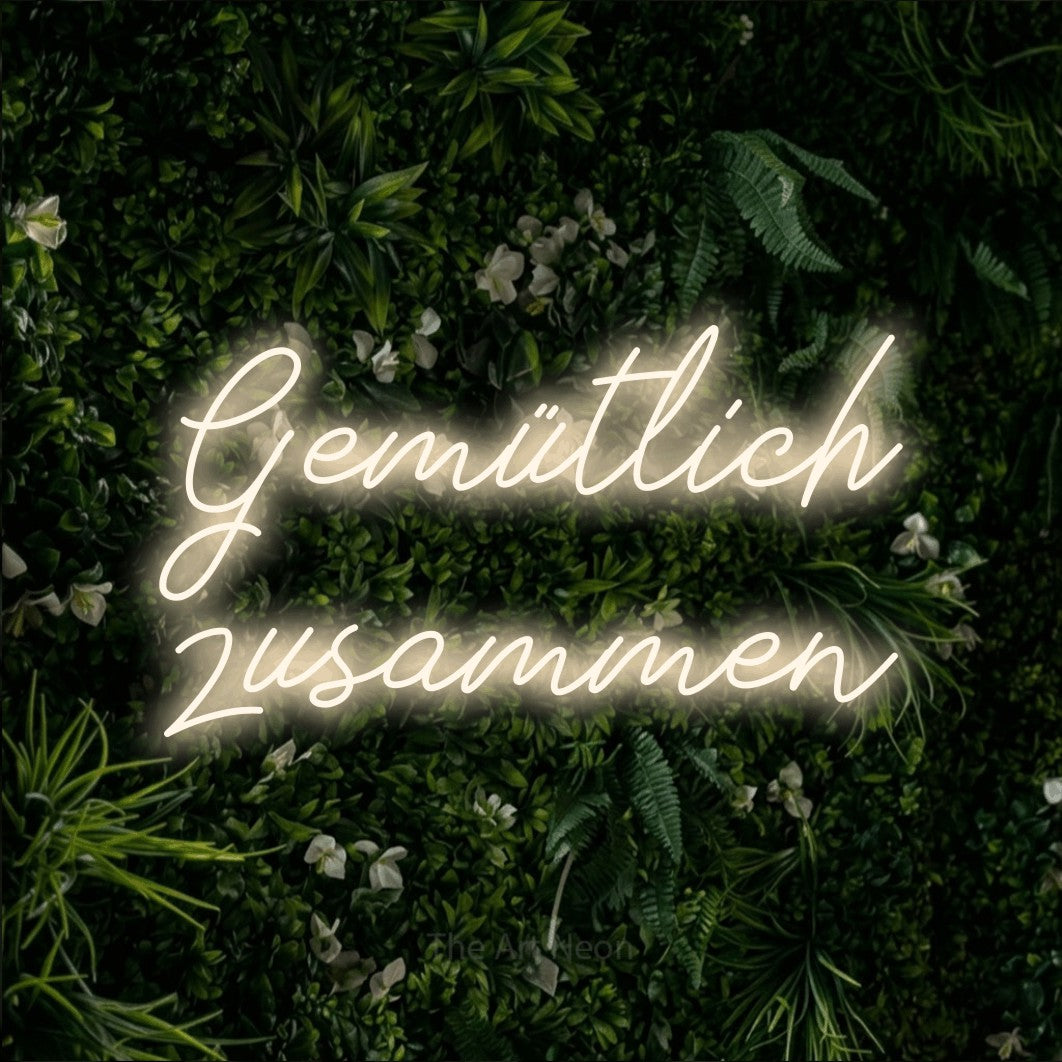 LED neon sign reading “Gemütlich zusammen”, arranged in 2 lines.