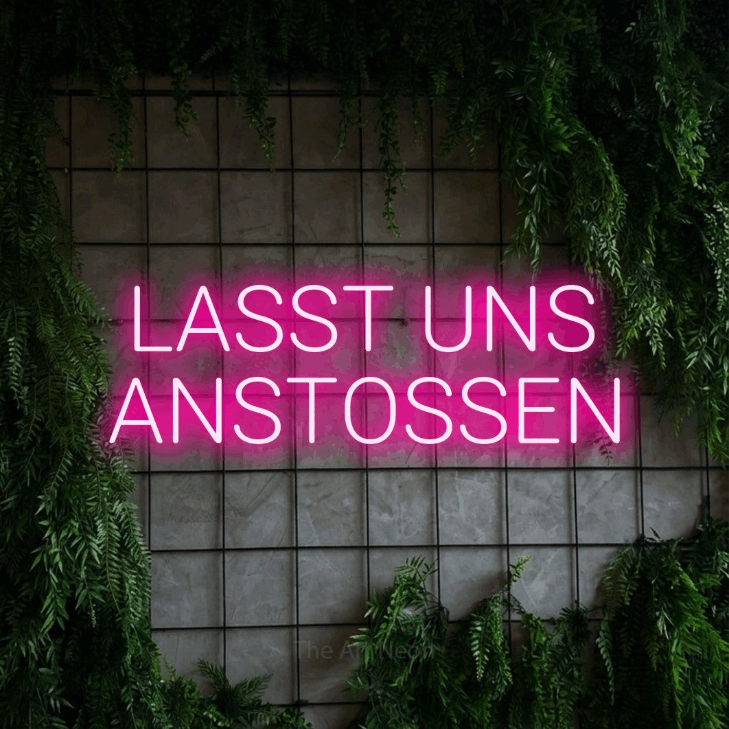 LED neon sign reading “LASST UNS ANSTOSSEN”, arranged in 2 lines.