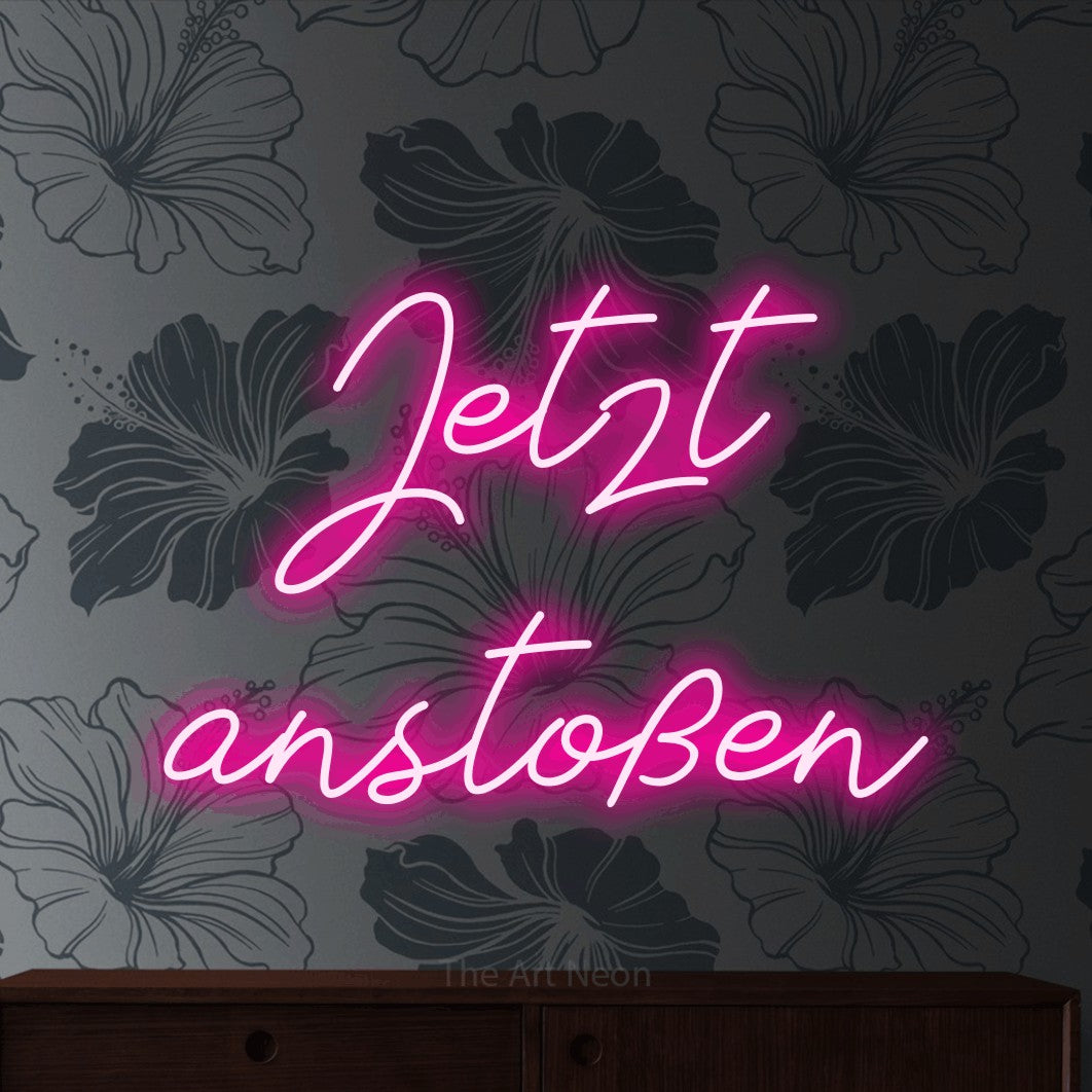 LED neon sign reading “Jetzt anstoßen”, arranged in 2 lines.