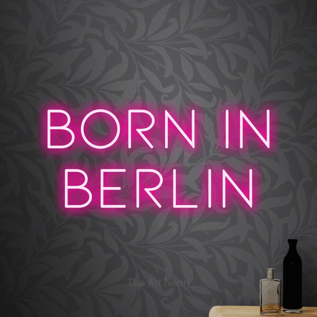LED neon sign reading “Born in Berlin”, arranged in 2 lines.