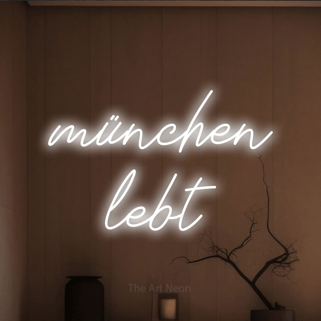 LED neon sign reading “münchen lebt”, arranged in 2 lines.