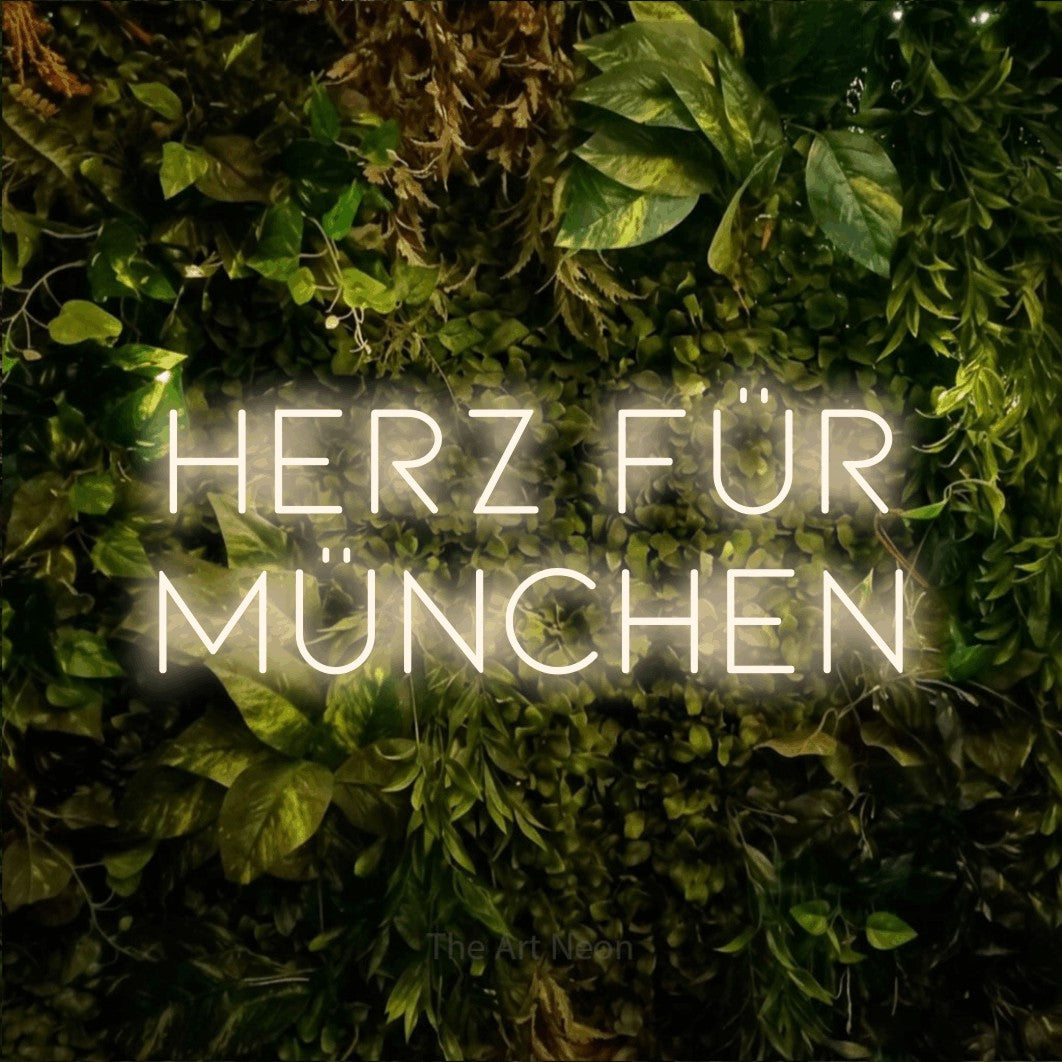 LED neon sign reading “HERZ FÜR MÜNCHEN”, arranged in 2 lines.