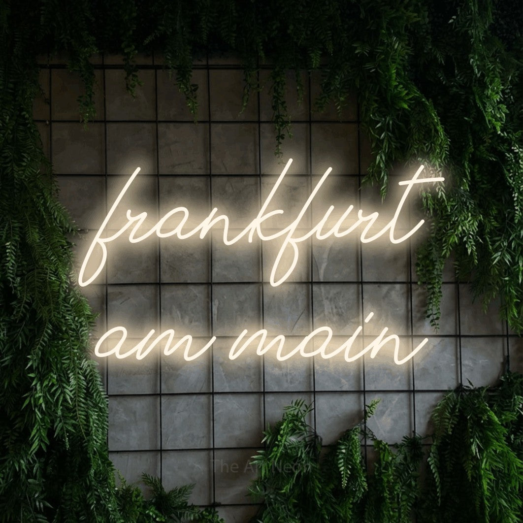LED neon sign reading “frankfurt am main”, arranged in 2 lines.