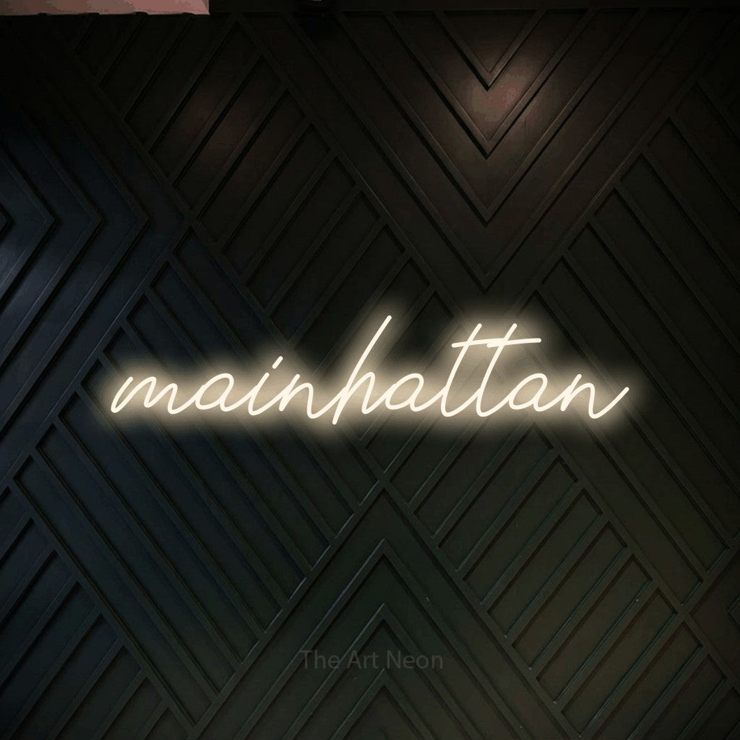 LED neon sign reading “mainhattan”, arranged in a single line.