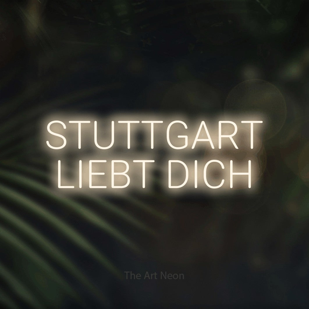 LED neon sign reading “STUTTGART LIEBT DICH”, arranged in 2 lines.