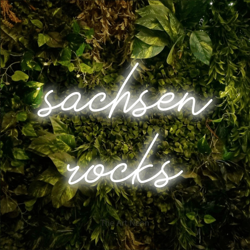 LED neon sign reading “sachsen rocks”, arranged in 2 lines.