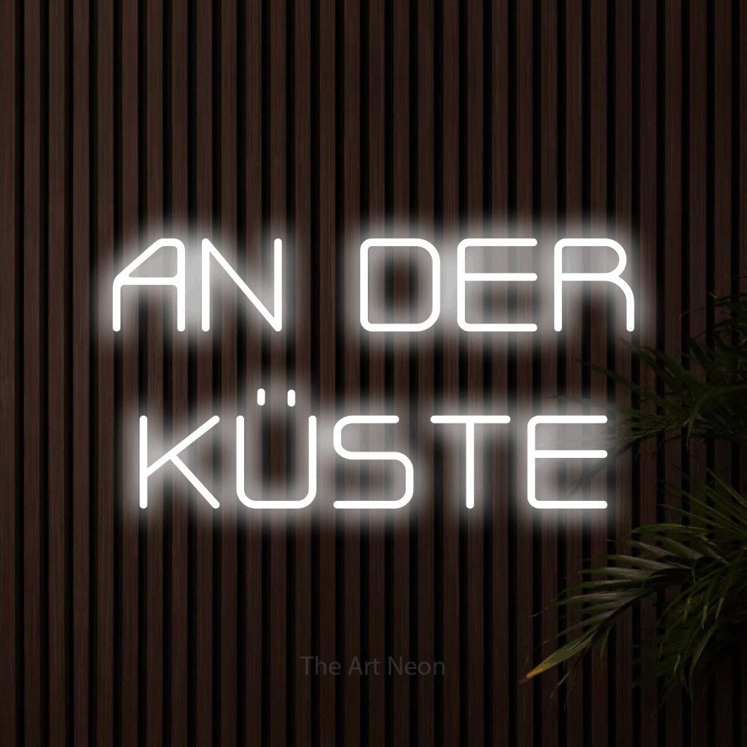 LED neon sign reading “AN DER KÜSTE”, arranged in 2 lines.