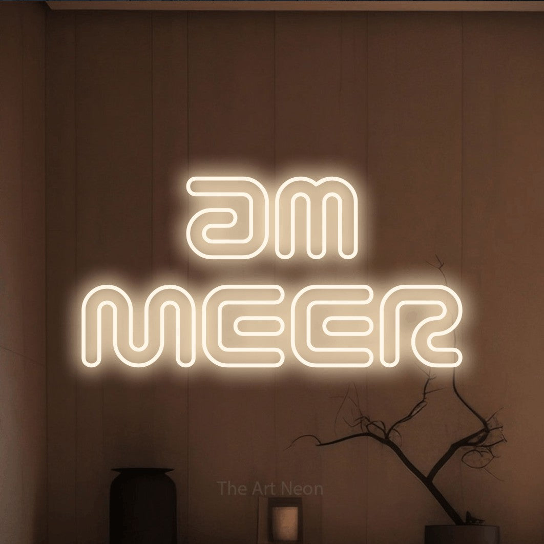 LED neon sign reading “am MEER”, arranged in 2 lines.