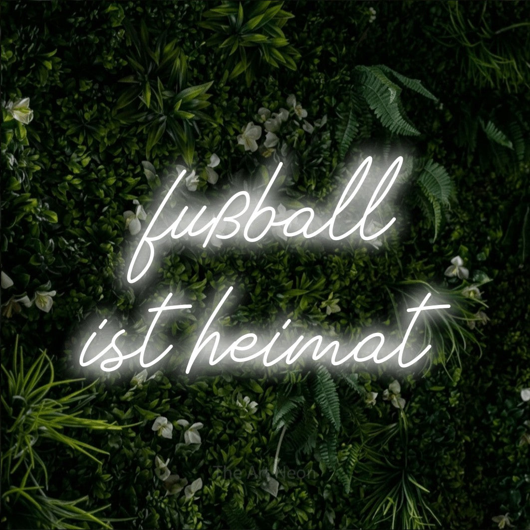 LED neon sign reading “fußball ist heimat”, arranged in 2 lines.