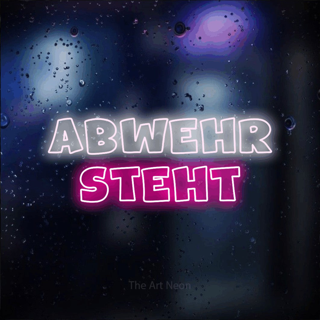 LED neon sign reading “Abwehr steht”, arranged in 2 lines.