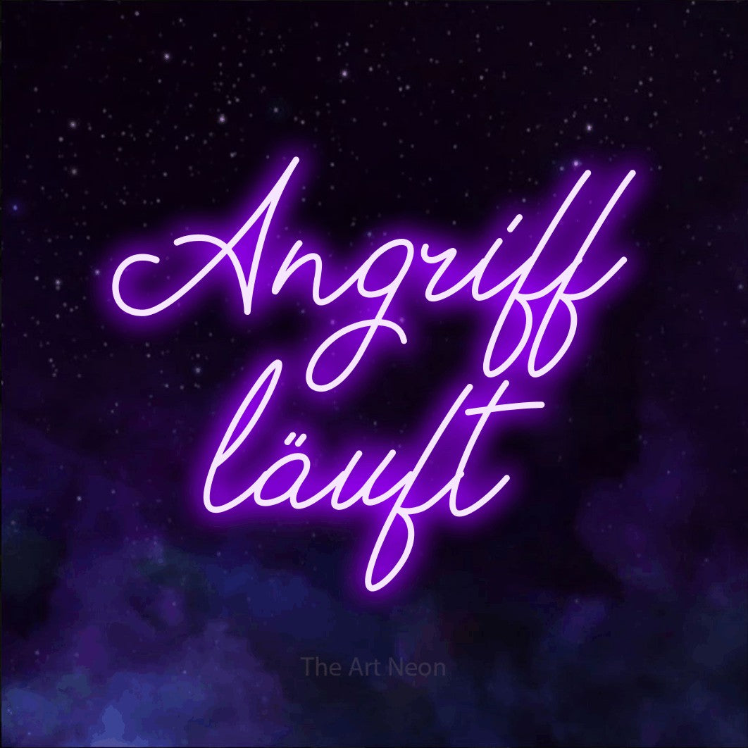 LED neon sign reading “Angriff läuft”, arranged in 2 lines.