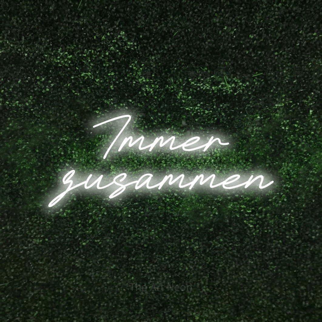 LED neon sign reading “Immer zusammen”, arranged in 2 lines.