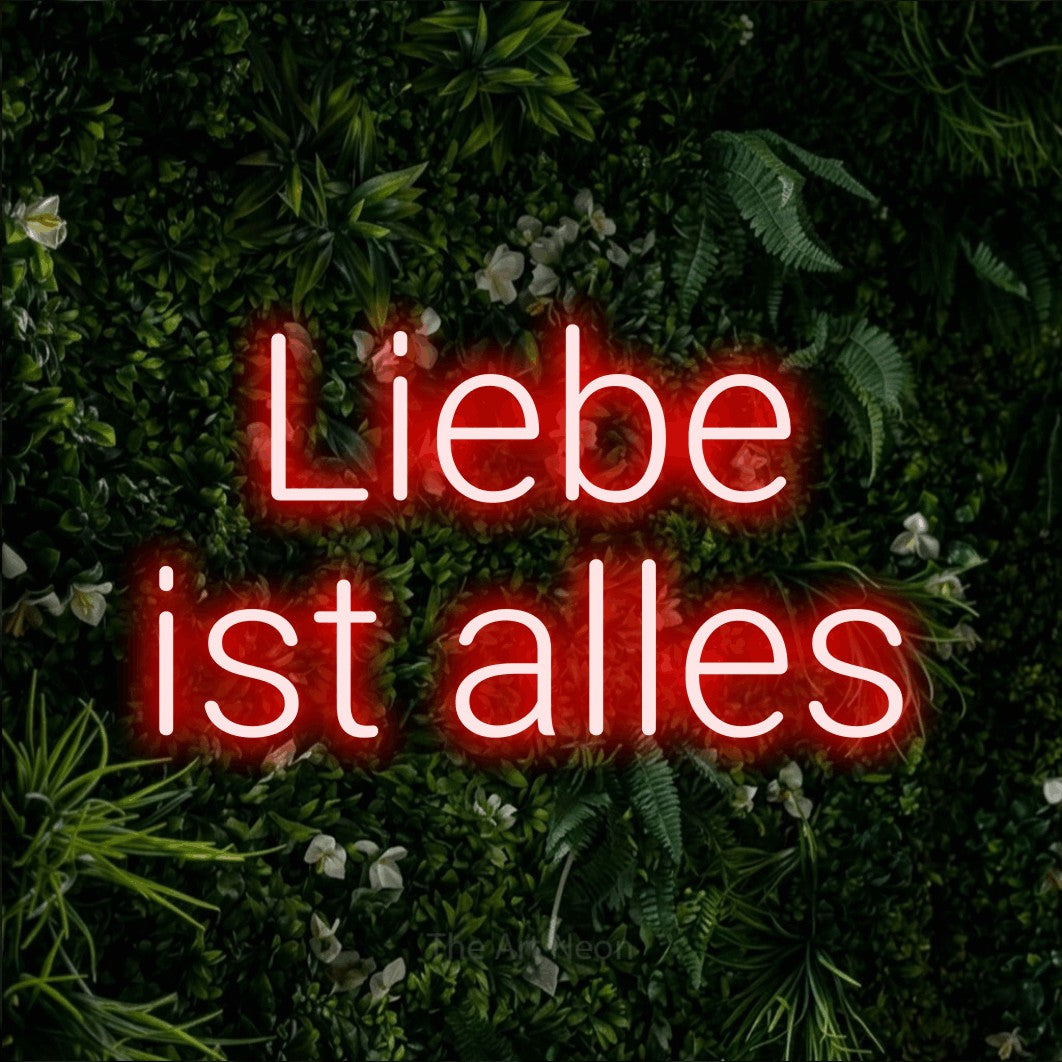 LED neon sign reading “Liebe ist alles”, arranged in 2 lines.