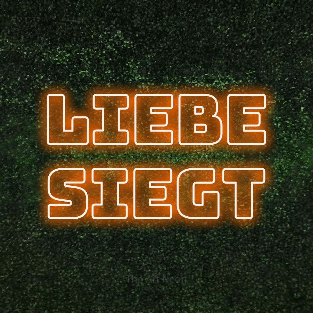 LED neon sign reading “liebe siegt”, arranged in 2 lines.