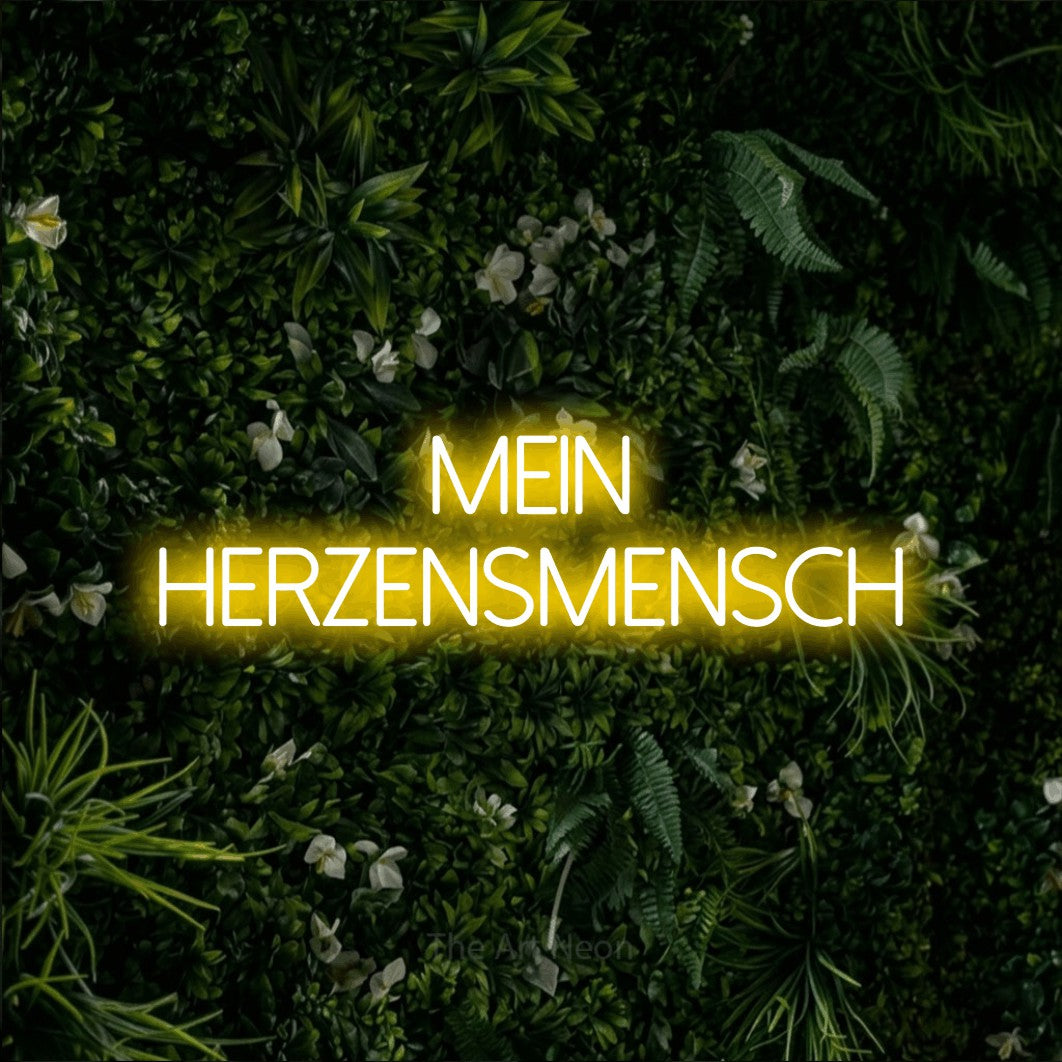 LED neon sign reading “mein herzensmensch”, arranged in 2 lines.
