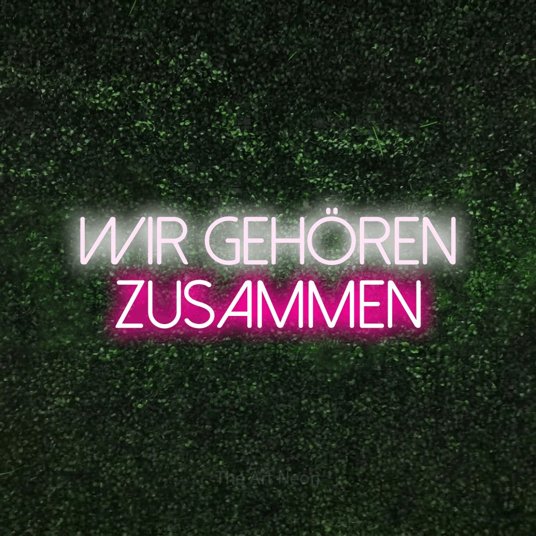 LED neon sign reading “Wir gehören zusammen”, arranged in 2 lines.