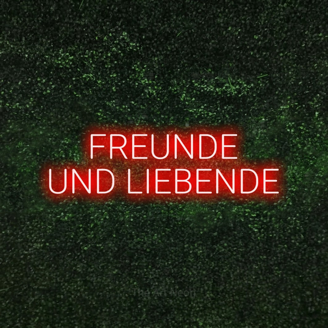 LED neon sign reading “FREUNDE UND LIEBENDE”, arranged in 2 lines.