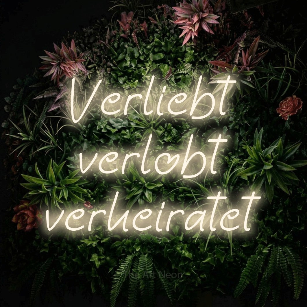 LED neon sign reading “Verliebt verlobt verheiratet”, arranged in 3 lines.