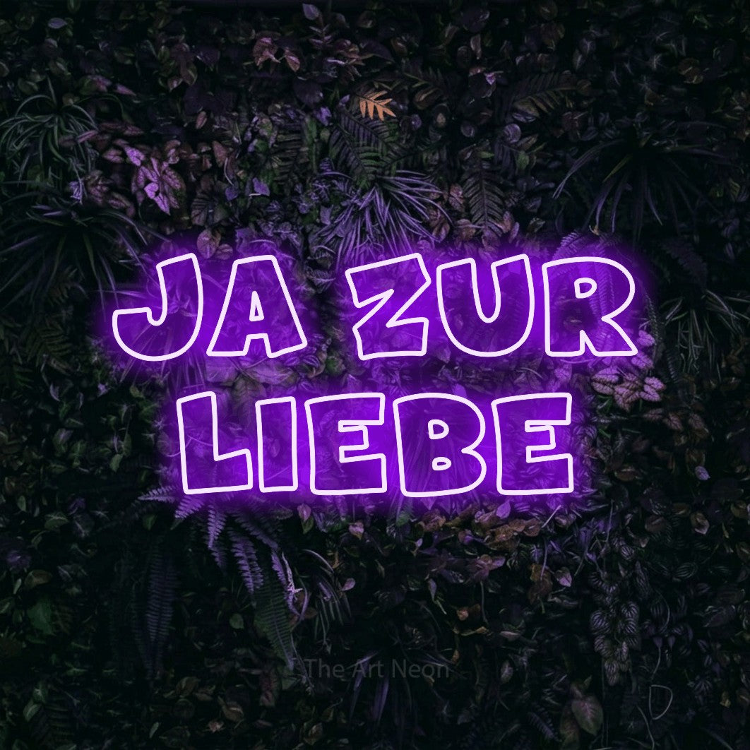 LED neon sign reading “JA ZUR LIEBE”, arranged in 2 lines.