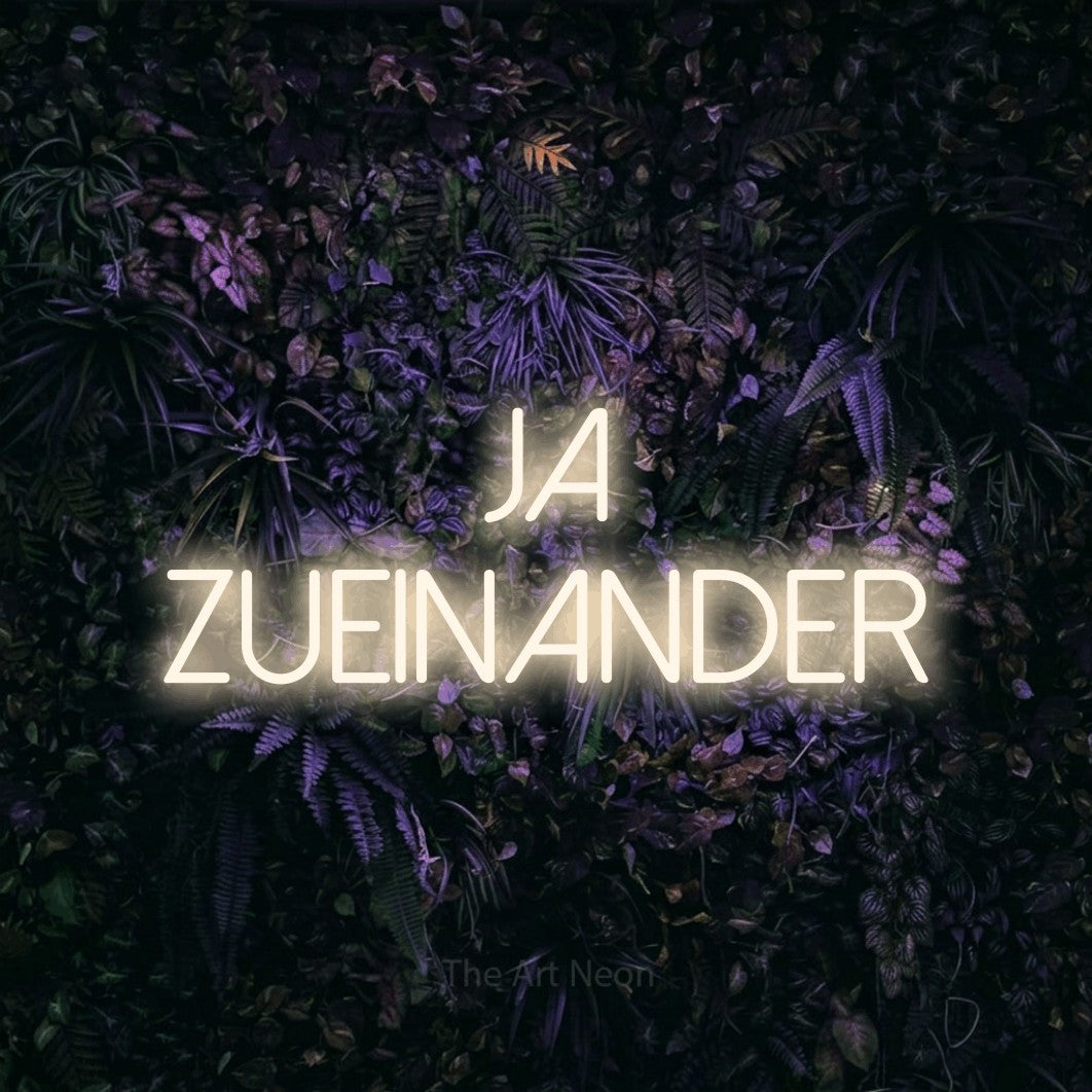 LED neon sign reading “ja zueinander”, arranged in 2 lines.
