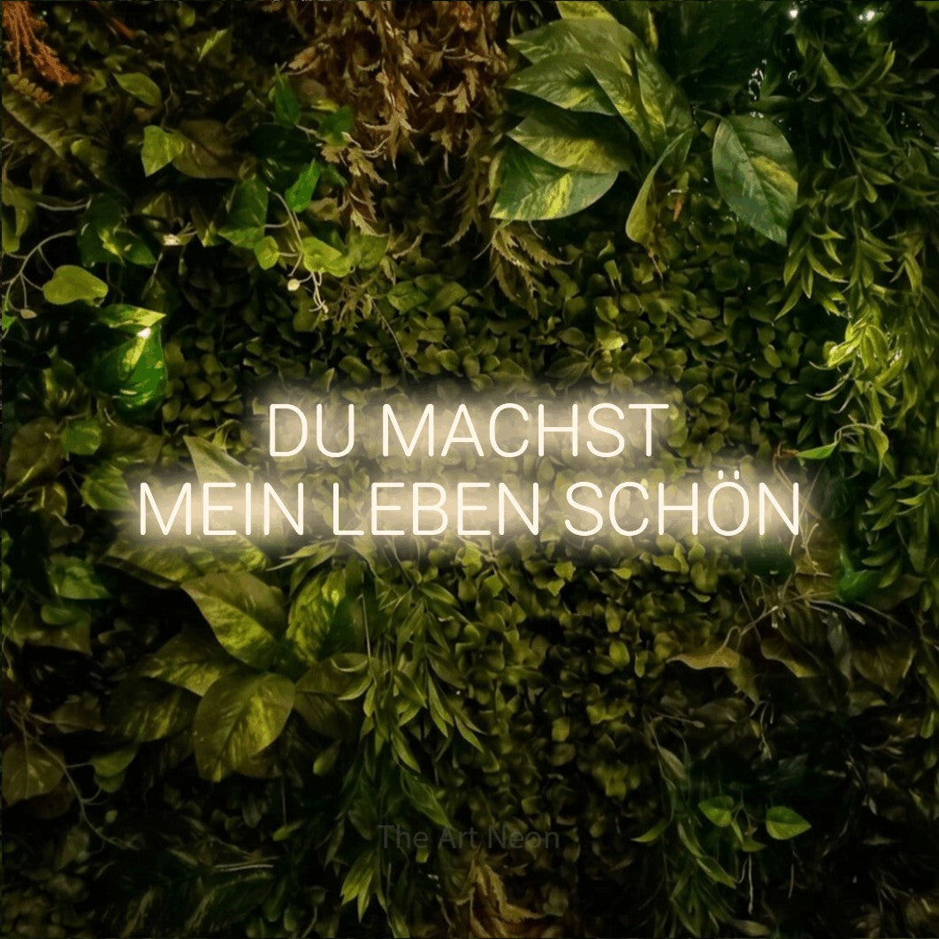 LED neon sign reading “DU MACHST MEIN LEBEN SCHÖN”, arranged in 2 lines.