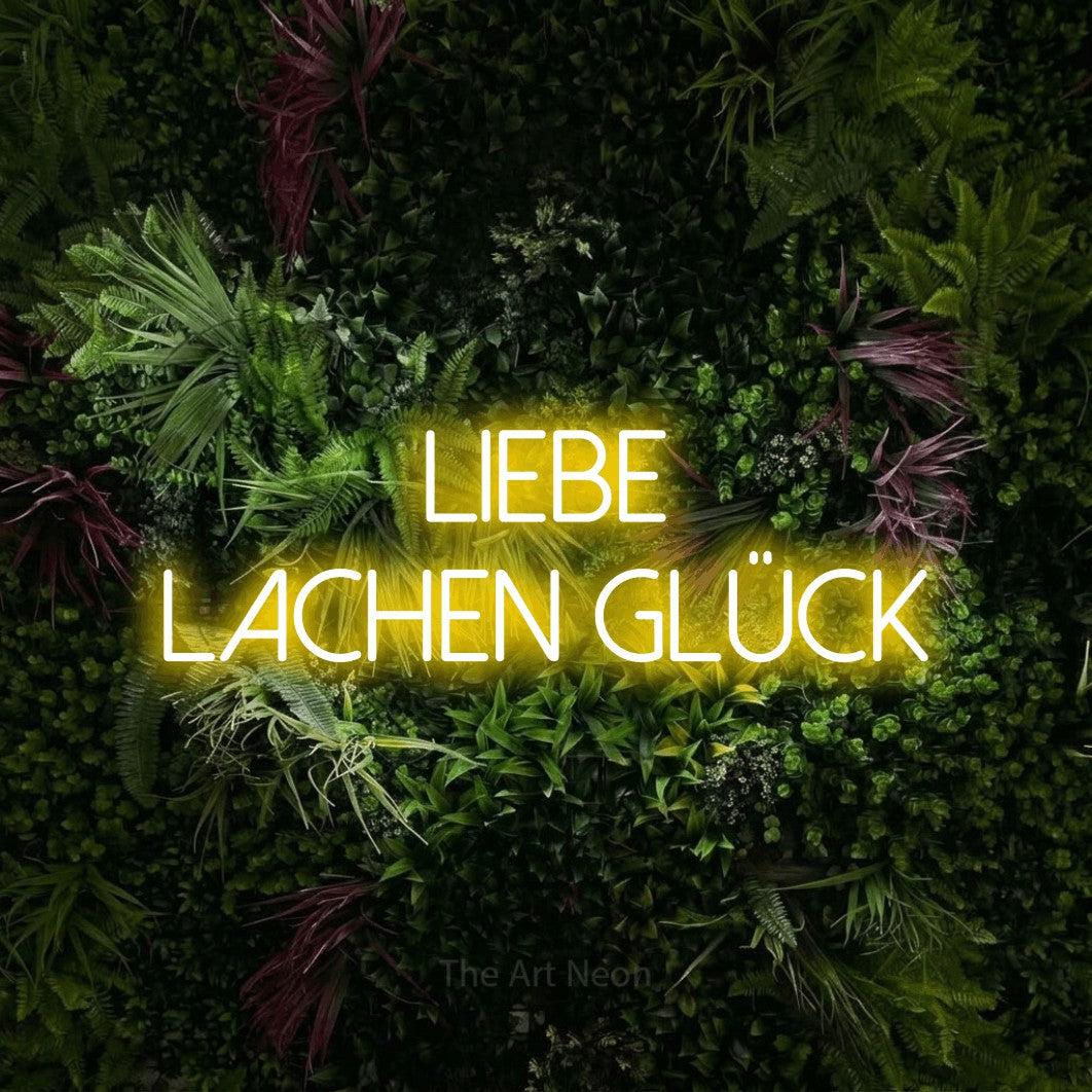 LED neon sign reading “Liebe Lachen Glück”, arranged in 2 lines.