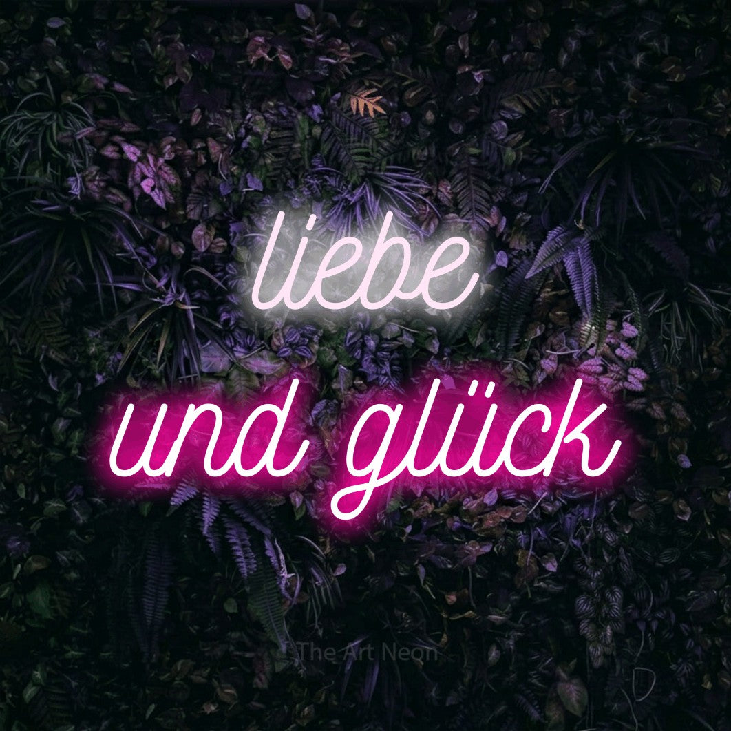 LED neon sign reading “liebe und glück”, arranged in 2 lines.
