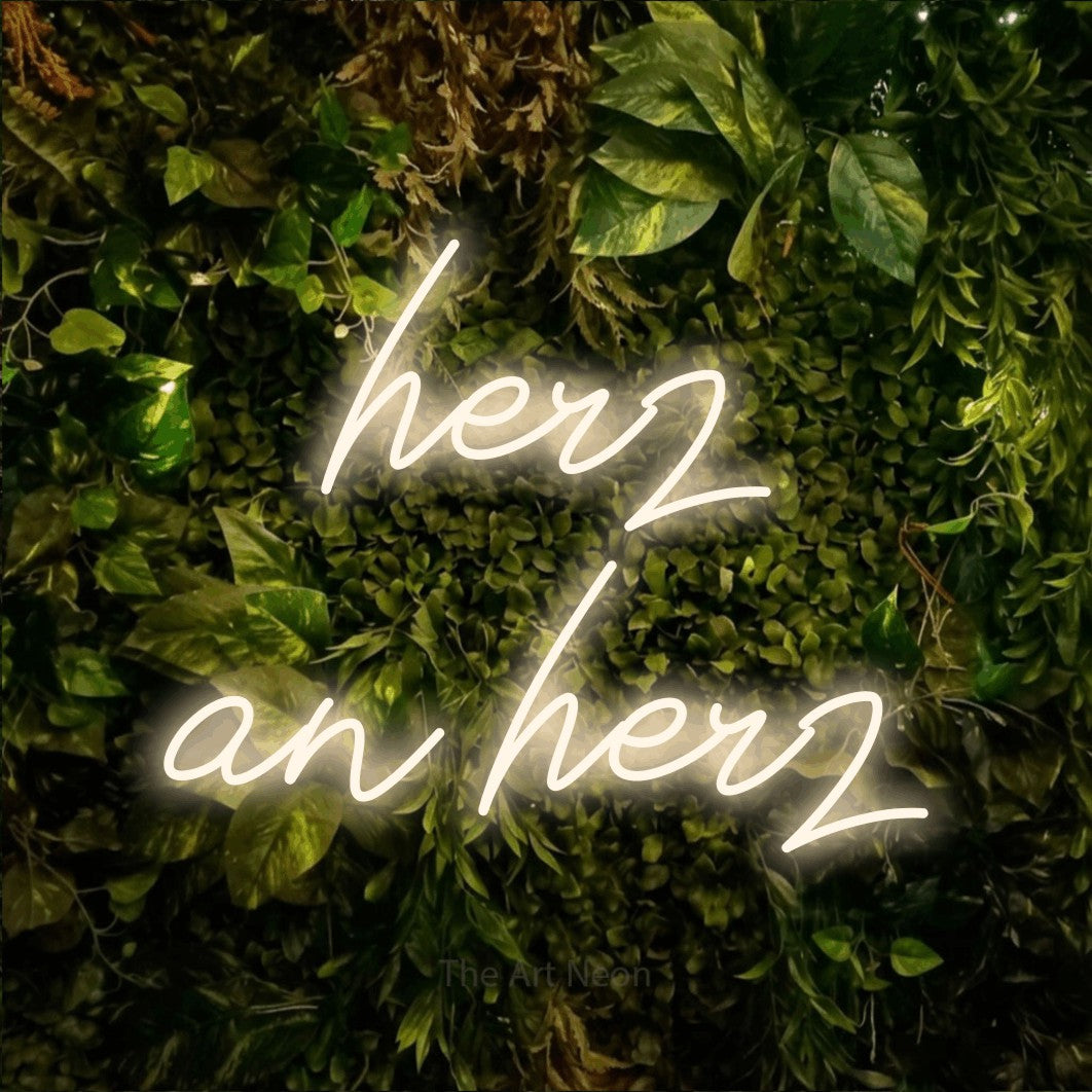 LED neon sign reading “herz an herz”, arranged in 2 lines.