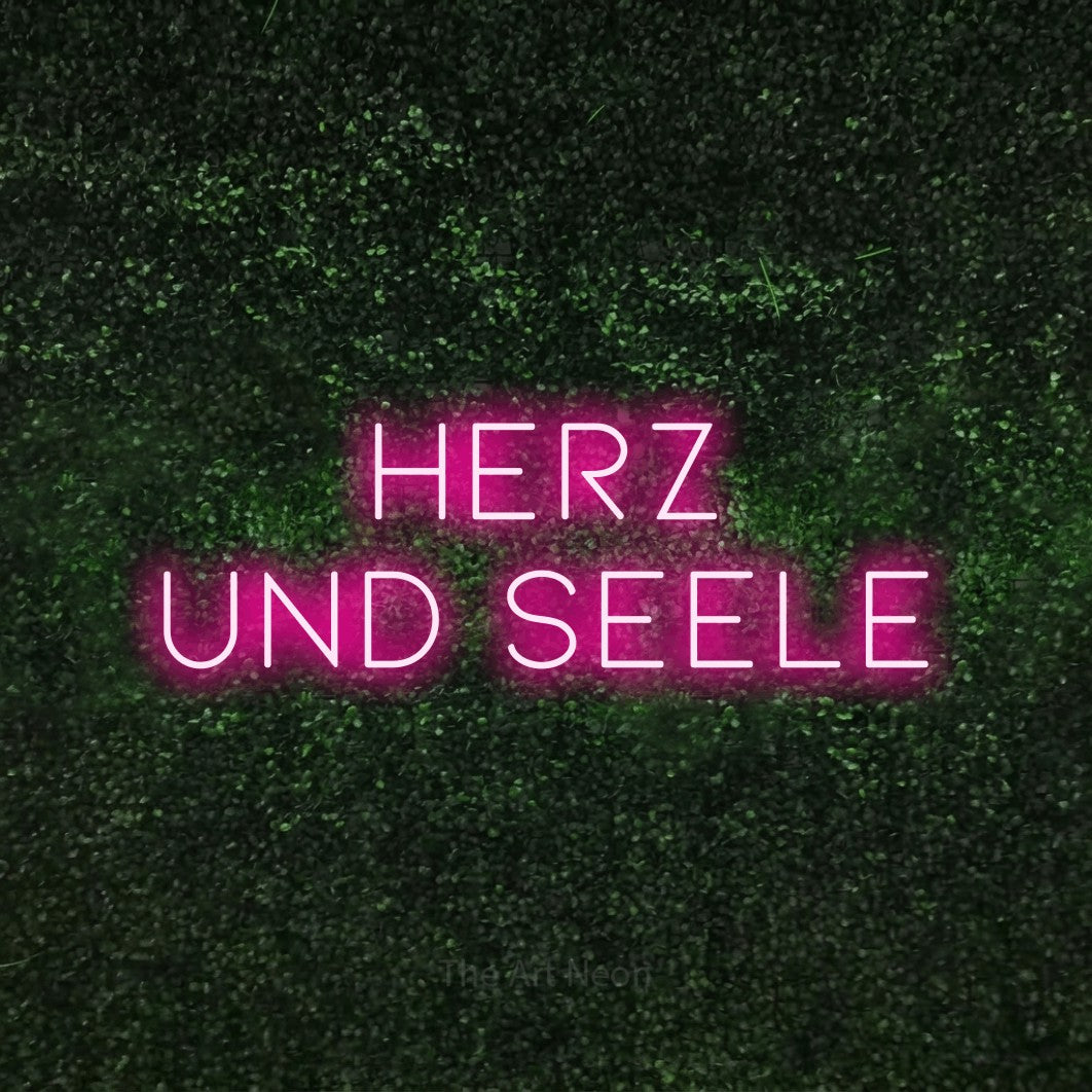 LED neon sign reading “HERZ UND SEELE”, arranged in 2 lines.