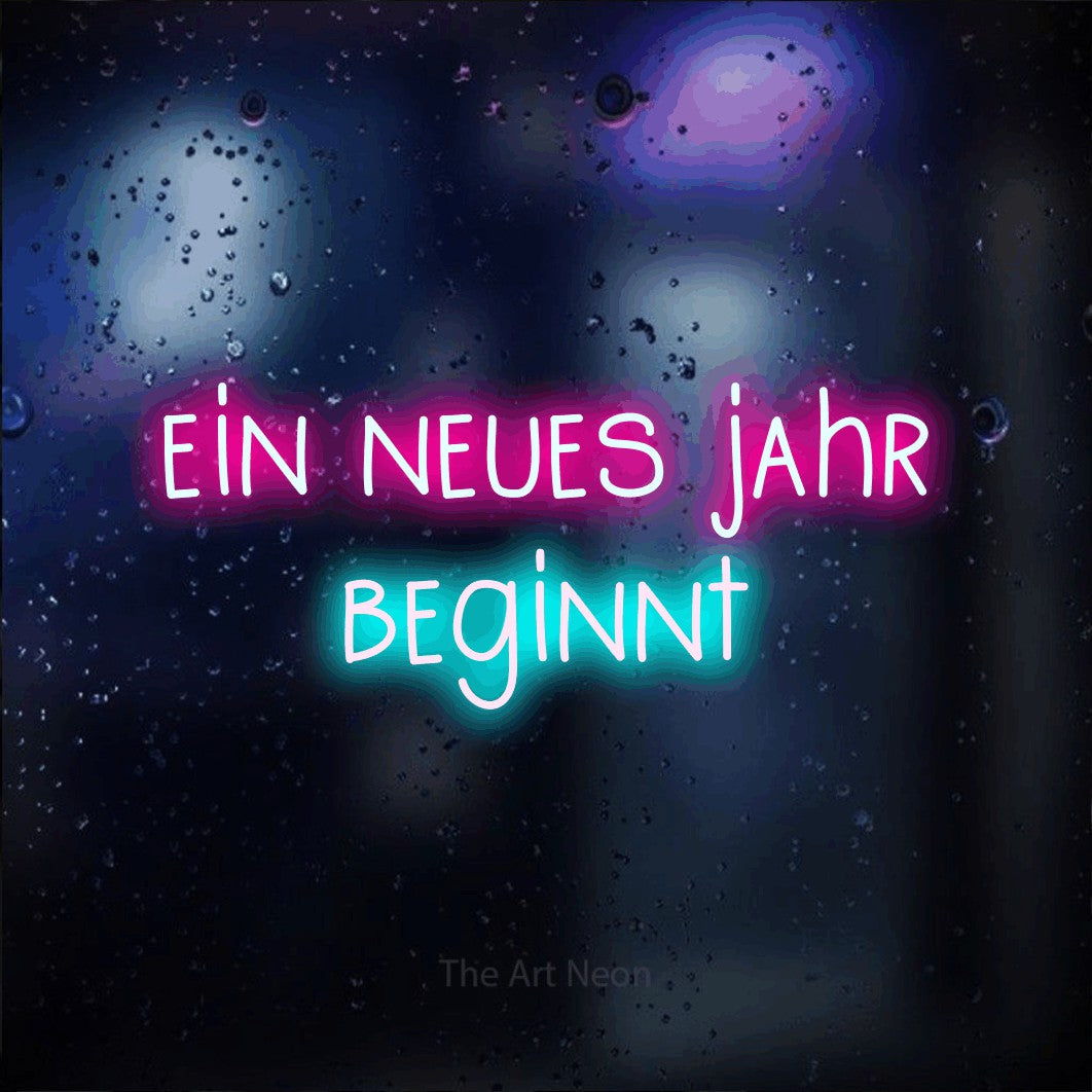LED neon sign reading “ein neues jahr beginnt”, arranged in 2 lines.
