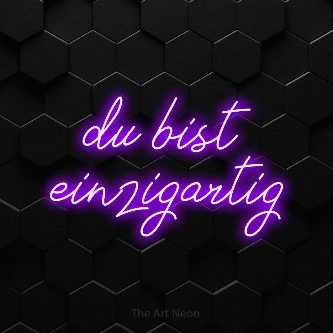 LED neon sign reading “du bist einzigartig”, arranged in 2 lines.