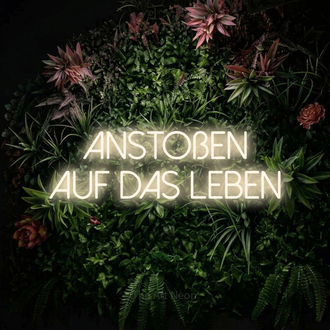 LED neon sign reading “anstoßen auf das leben”, arranged in 2 lines.