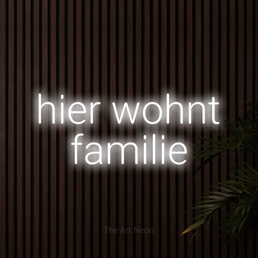 LED neon sign reading “hier wohnt familie”, arranged in 2 lines.