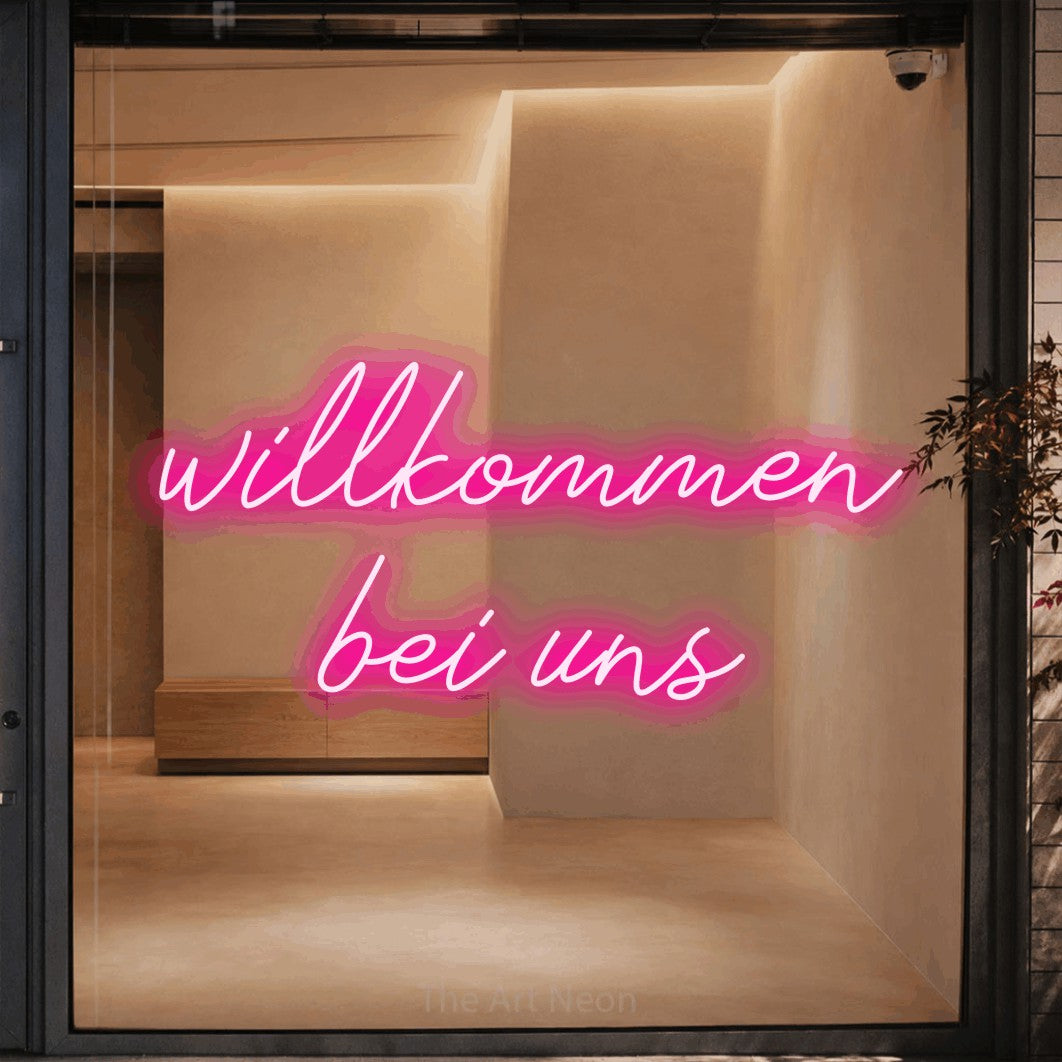 LED neon sign reading “willkommen bei uns”, arranged in 2 lines.