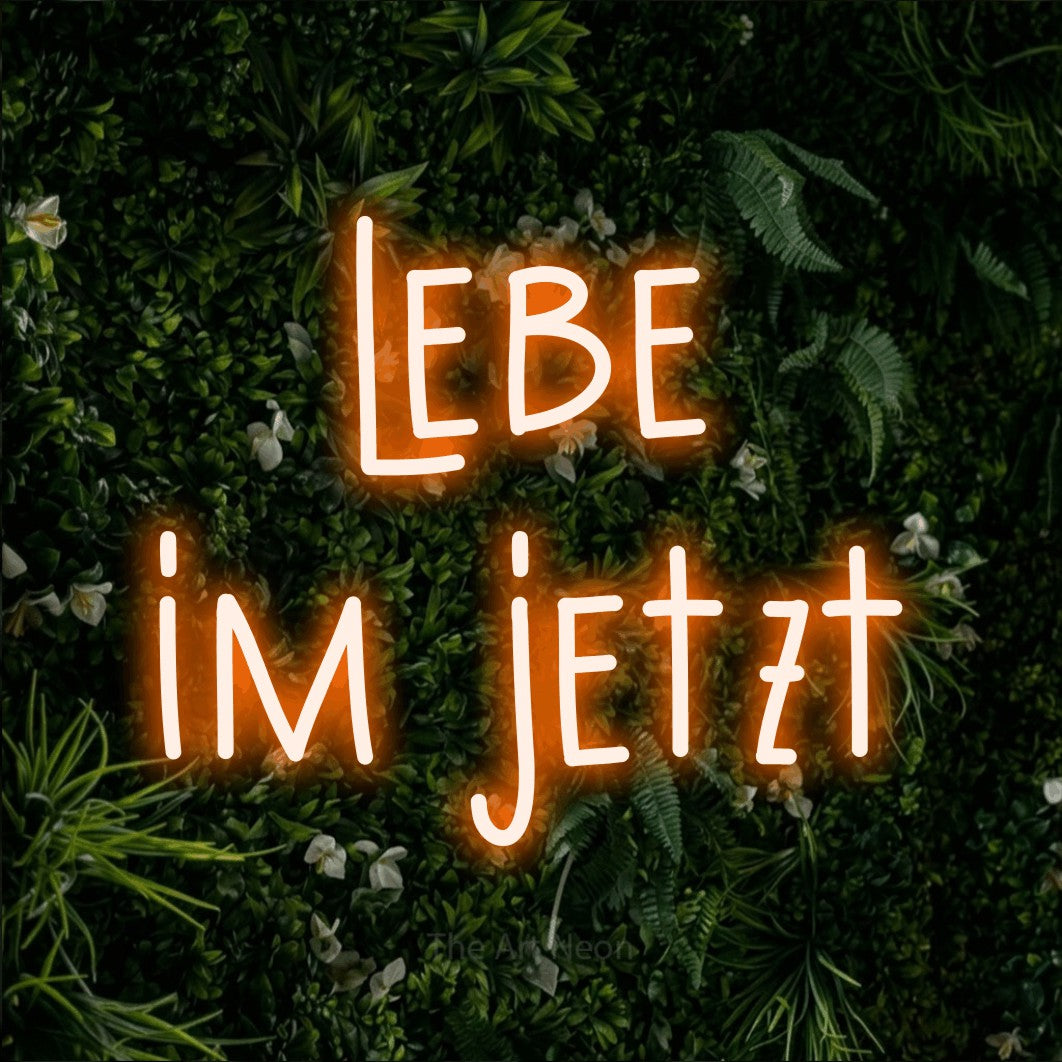 LED neon sign reading “lebe im jetzt”, arranged in 2 lines.