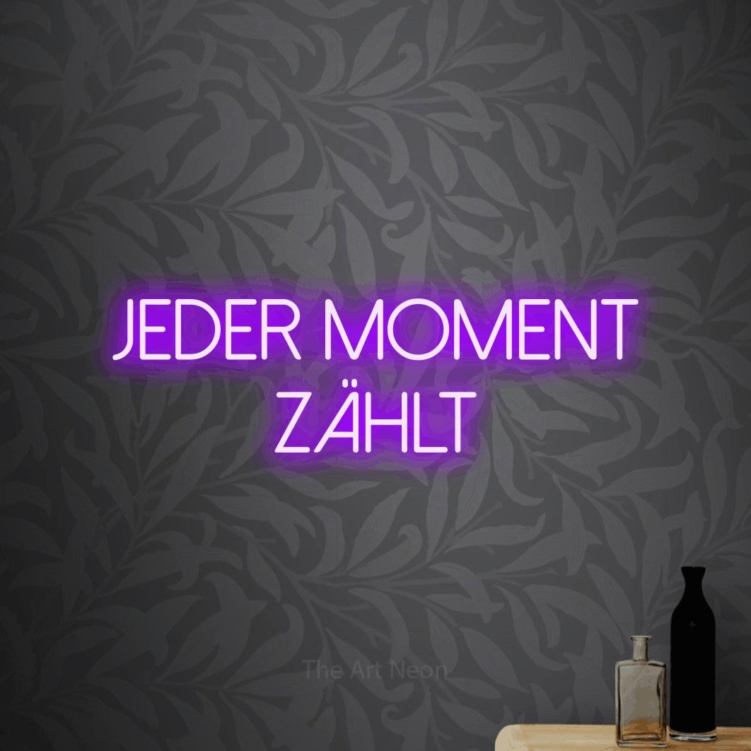 LED neon sign reading “Jeder Moment zählt”, arranged in 2 lines.