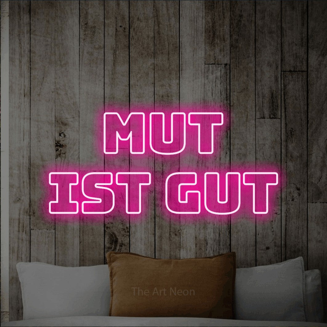 LED neon sign reading “MUT ist gut”, arranged in 2 lines.