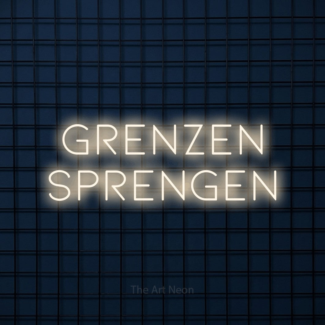 LED neon sign reading “grenzen sprengen”, arranged in 2 lines.