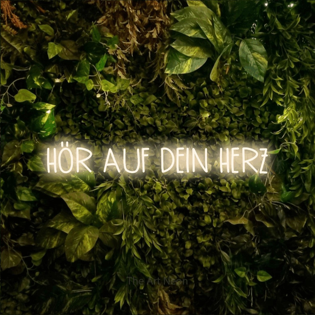 LED neon sign reading “HÖR AUF DEIN HERZ”, arranged in a single line.