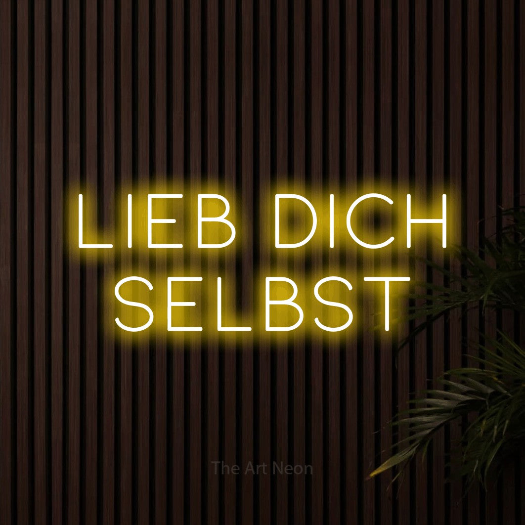 LED neon sign reading “Lieb dich selbst”, arranged in 2 lines.
