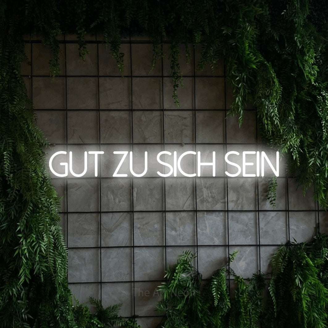 LED neon sign reading “GUT ZU SICH SEIN”, arranged in a single line.