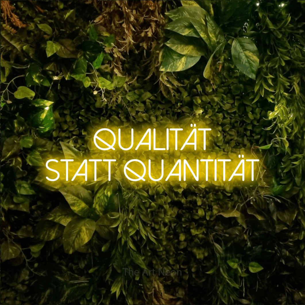 LED neon sign reading “Qualität statt Quantität”, arranged in 2 lines.