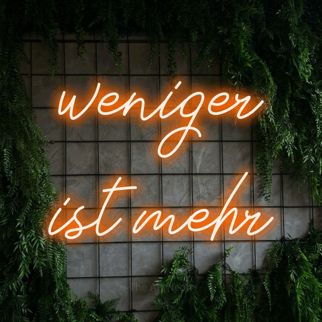 LED neon sign reading “weniger ist mehr”, arranged in 2 lines.